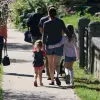 a group of people walking down a sidewalk