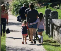 a group of people walking down a sidewalk