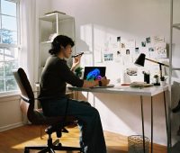 Person working at desk with laptop and phone