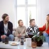 a group of people sitting around a table