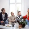 a group of people sitting around a table